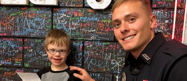 Officer Hopper with kindergarten student, Chase