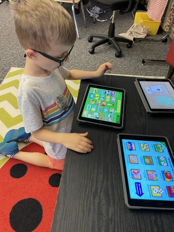 Kindergarten student looking at a tablet