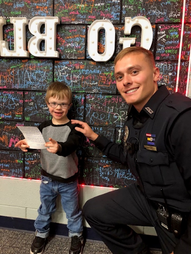 Officer Hopper with kindergarten student, Chase